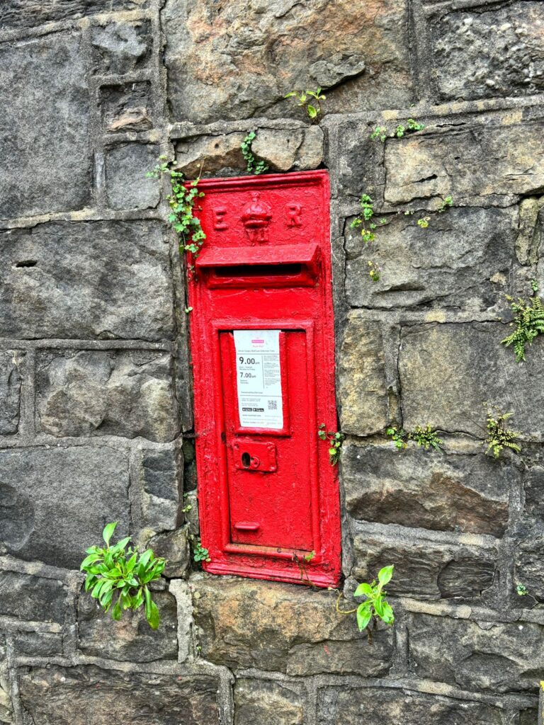 Image of the post-box in the wall of the church